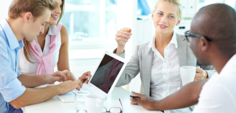 Group of friendly businesspeople having meeting