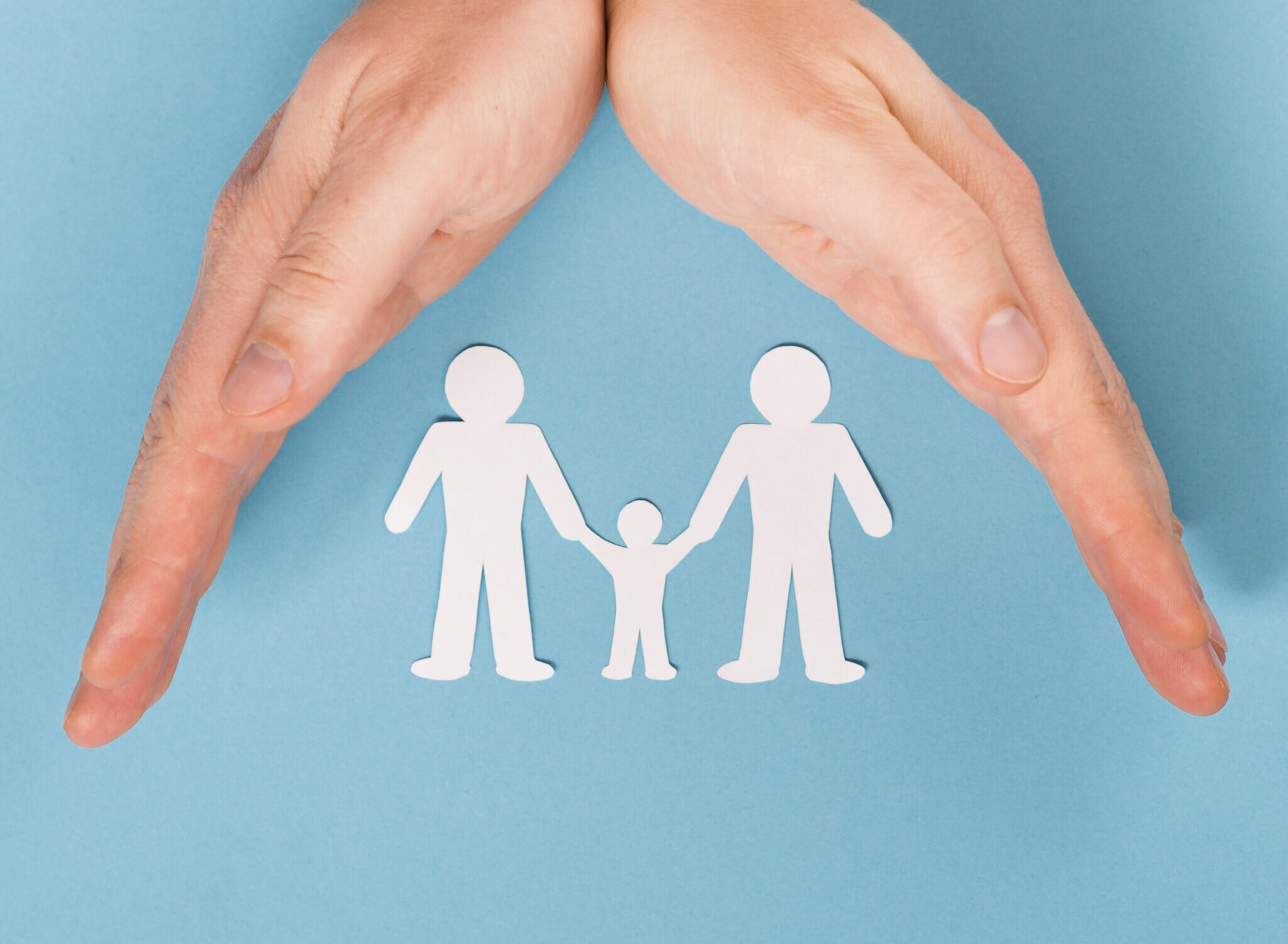 top-view-person-holding-hands-cute-paper-family-with-copy-space top-view-person-holding-hands-cute-paper-family-with-copy-space
